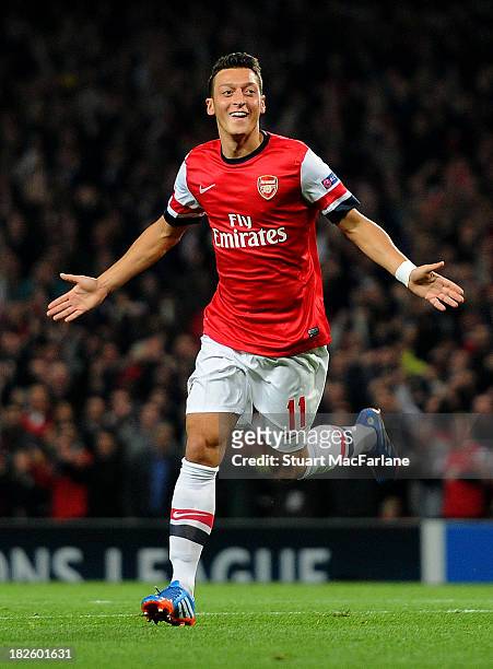 Mesut Oezil of Arsenal celebrates scoring his team's first goal during the UEFA Champions League Group F match between Arsenal FC and SSC Napoli at...