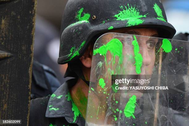 Police officer is seen stained with paint during a teacher protest against corruption in the office of Rio Governor Sergio Cabral, in Rio de Janeiro,...