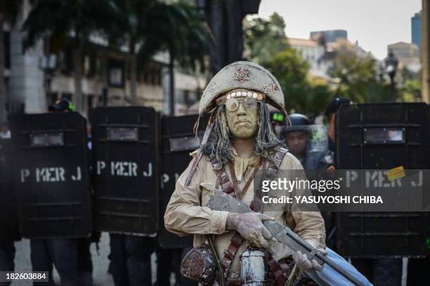 Street performer is seen during a teacher protest against corruption in the office of Rio Governor Sergio Cabral, in Rio de Janeiro, Brazil on...