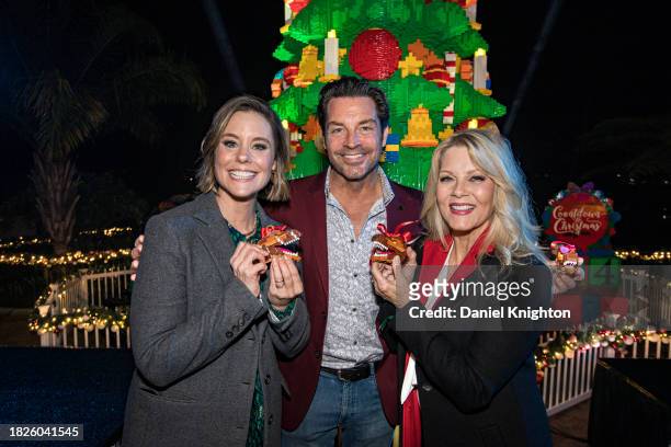 Actors Ashley Williams, Brennan Elliott and Barbara Niven pose during the LEGOLAND California Resort's holiday tree lighting for "Brick' The Halls!"...