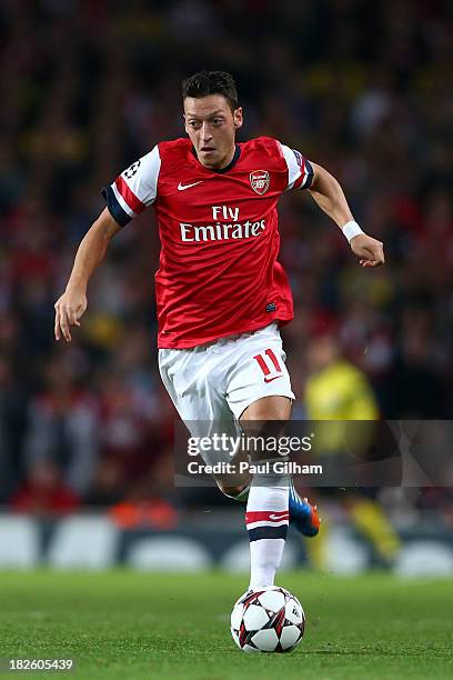 Mesut Oezil of Arsenal runs with the ball during UEFA Champions League Group F match between Arsenal FC and SSC Napoli at Emirates Stadium on October...