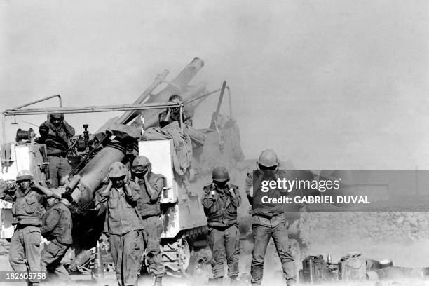 Israeli soldiers plug their ears as they fire shells in October 1973 at the Syrian front lines on the Syrian Golan Heights, two weeks after the...