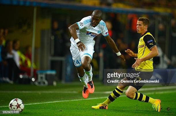 Rod Fanni of Olympique Marseille avoids a challenge from Erik Durm of Borussia Dortmund during the UEFA Champions League Group F match between...