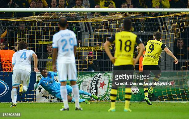 Robert Lewandowski of Borussia Dortmund scores from the penalty spot during the UEFA Champions League Group F match between Borussia Dortmund and...