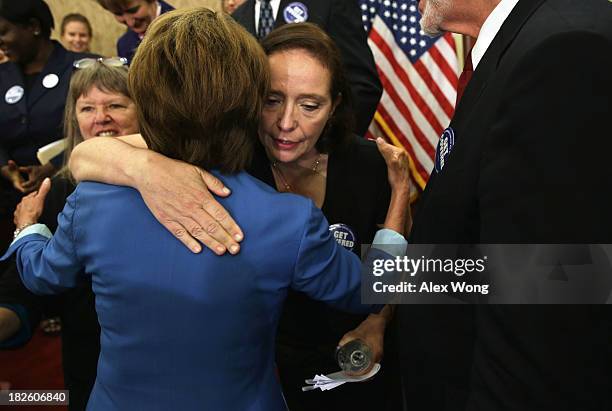 House Minority Leader Rep. Nancy Pelosi hugs Maureen Murphy of Alexandria, Virginia, who was rejected for coverage by health insurance companies...