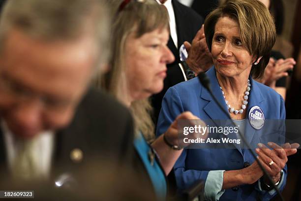 House Minority Leader Rep. Nancy Pelosi listens to the story of Leslie Boyd of Candler, North Carolina, who has lost her son to cancer, during a...