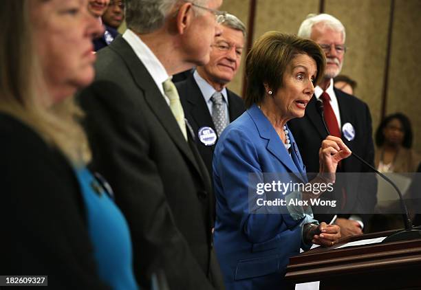 House Minority Leader Rep. Nancy Pelosi speaks as Leslie Boyd of Candler, North Carolina, who has lost her son to cancer, Senate Majority Leader Sen....