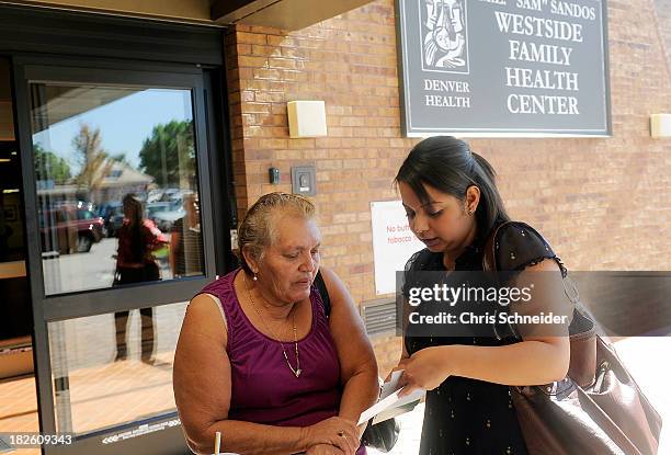 Lida Galindo, right, of Servicios de la Raza, talks with Mirian Morales left, about the Affordable Care Act outside of the Denver Health Westside...