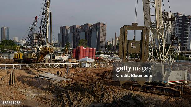 Workers operate heavy equipment at the construction site of Tecnisa SA's Jardim das Perdizes housing development in Sao Paulo, Brazil, on Friday,...