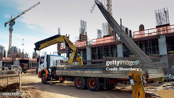 Crane lifts building materials at the construction site of Tecnisa SA's Jardim das Perdizes housing development in Sao Paulo, Brazil, on Friday,...