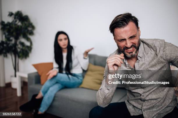 young couple in a disagreement over family matters - mad girlfriend stock pictures, royalty-free photos & images