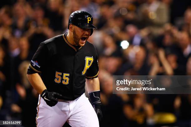 Russell Martin of the Pittsburgh Pirates celebrates his solo home run in the second inning against the Cincinnati Reds during the National League...