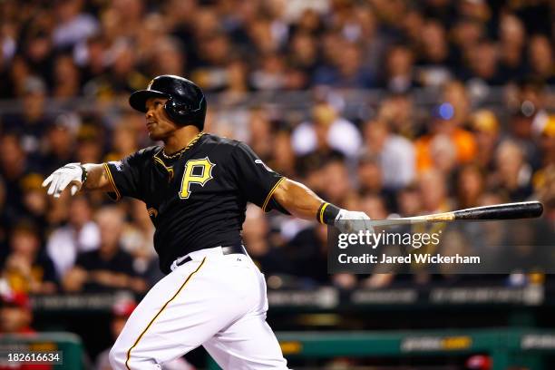 Marlon Byrd of the Pittsburgh Pirates watches his second inning solo home run against the Cincinnati Reds during the National League Wild Card game...