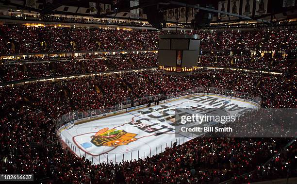 Fans wear light-up bracelets for the Chicago Blackhawks pre-game ceremony before the home opener against the Washington Capitals on October 1, 2013...