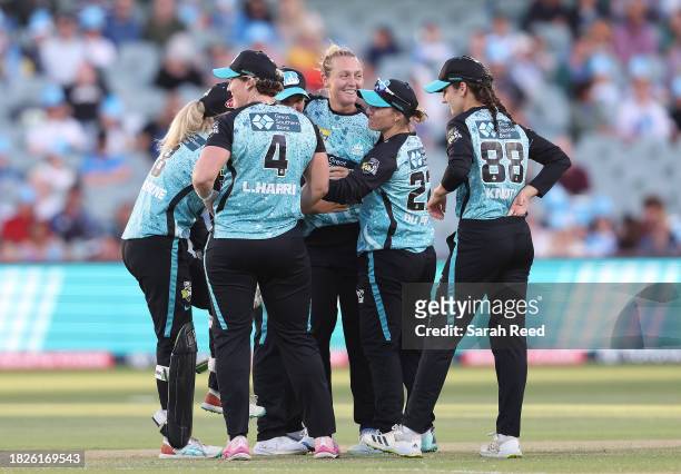 Nicola Hancock of the Brisbane Heat celebrates the wicket of Tahlia McGrath of the Adelaide Strikers for 38 runs with team mates during the WBBL...