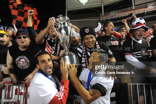 Dwayne De Rosario of D.C. United and Will Chang General Partner of D.C. United, along with fans celebrate their 1-0 win over Real Salt Lake at Rio...