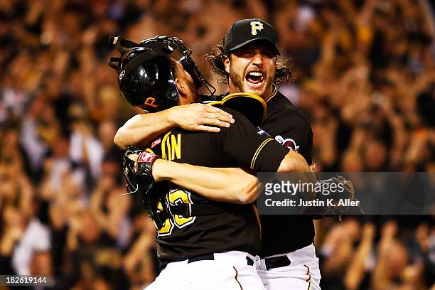 Jason Grilli and Russell Martin of the Pittsburgh Pirates celebrate their 6 to 2 win over the Cincinnati Reds during the National League Wild Card...