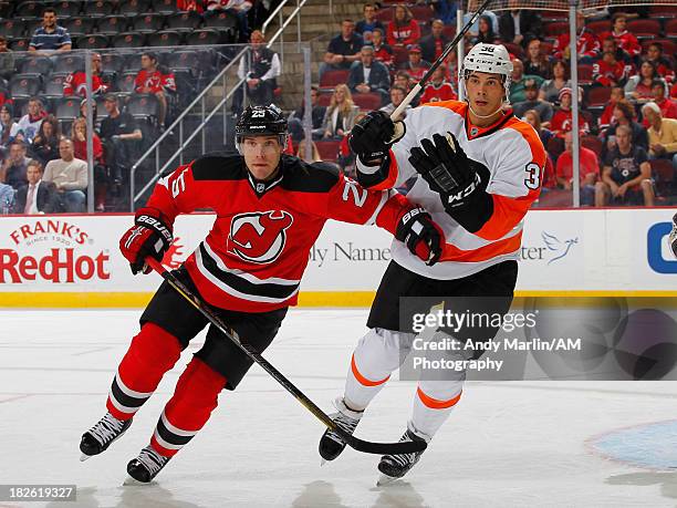 Rostislav Olesz of the New Jersey Devils and Oliver Lauridsen of the Philadelphia Flyers skate for position during the preseason game at Prudential...