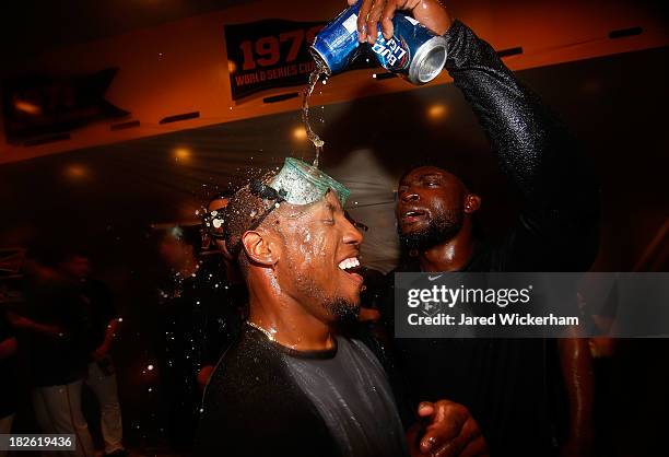 Starling Marte and Felix Pie of the Pittsburgh Pirates celebrate in the clubhouse following their 6-2 win against the Cincinnati Reds during the...