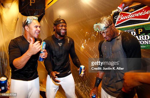 Jose Tabata, Felix Pie and Starling Marte of the Pittsburgh Pirates celebrate after defeating the Cincinnati Reds 6-2 in the National League Wild...