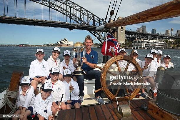 Brett Lee poses on Sydney Harbour with the ICC Cricket World Cup trophy and junior cricketers from Mosman cricket club during celebrations to mark...