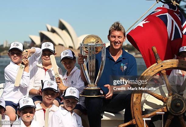 Brett Lee poses on Sydney Harbour with the ICC Cricket World Cup trophy and junior cricketers from Mosman cricket club during celebrations to mark...