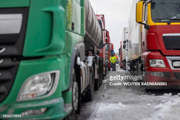 Ukrainian truck drivers are seen next to Ukrainian trucks on the parking lot near Korczowa Polish-Ukrainian border crossing, on December 5, 2023. In...