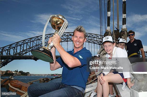 Brett Lee poses on Sydney Harbour with the ICC Cricket World Cup trophy and junior cricketers from Mosman cricket club during celebrations to mark...