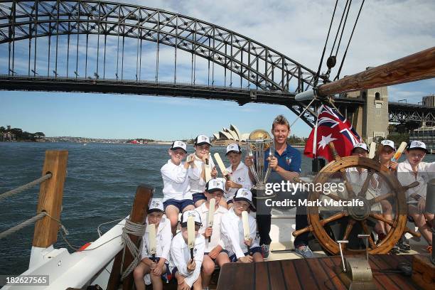 Brett Lee poses on Sydney Harbour with the ICC Cricket World Cup trophy and junior cricketers from Mosman cricket club during celebrations to mark...