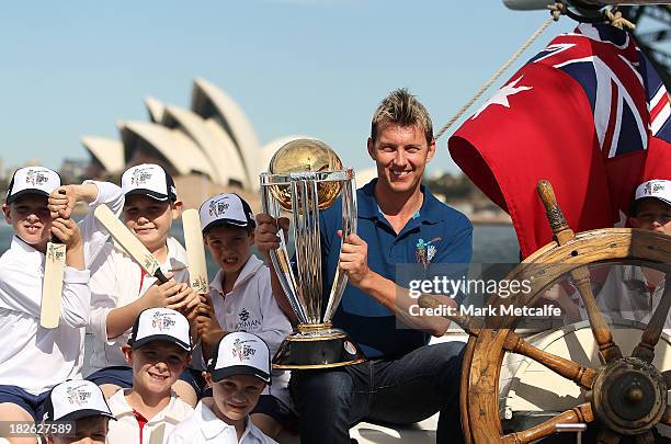 Brett Lee poses on Sydney Harbour with the ICC Cricket World Cup trophy and junior cricketers from Mosman cricket club during celebrations to mark...