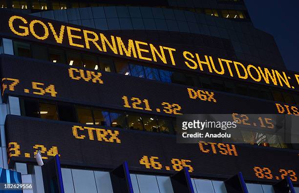 Times Square Stock Ticker displays a sign about governments's shutdown as well as stock exchange values on 1 October 2013 in New York City. After...