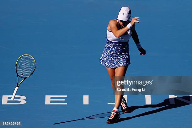 Svetlana Kuznetsova of Russia throw away the racket during her women's singles match against Andrea Petkovic of Germany on day five of the 2013 China...