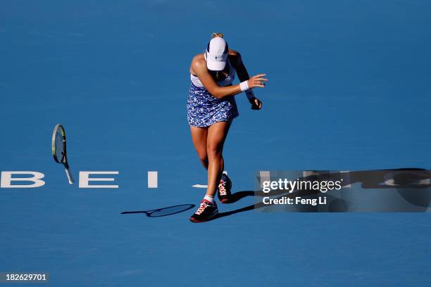 Svetlana Kuznetsova of Russia throw away the racket during her women's singles match against Andrea Petkovic of Germany on day five of the 2013 China...