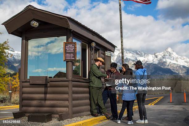 Park ranger Dustin Eads explained to a group of tourists from China who planed their vacation 6 months in advance where they were and were not...