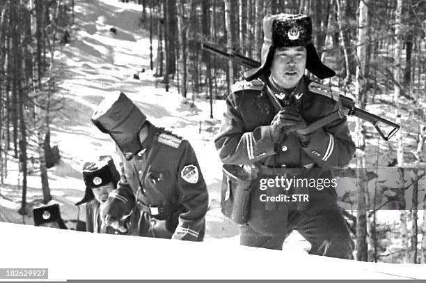 Chinese frontier troops patrol a snowy hillside on Shuangmu Mountain, bordering North Korea 17 April. China is stepping up vigilance along the border...