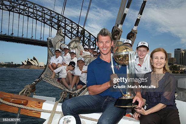 Brett Lee and NSW Minister for Sport Gabrielle Upton pose on Sydney Harbour with the ICC Cricket World Cup trophy and junior cricketers from Mosman...