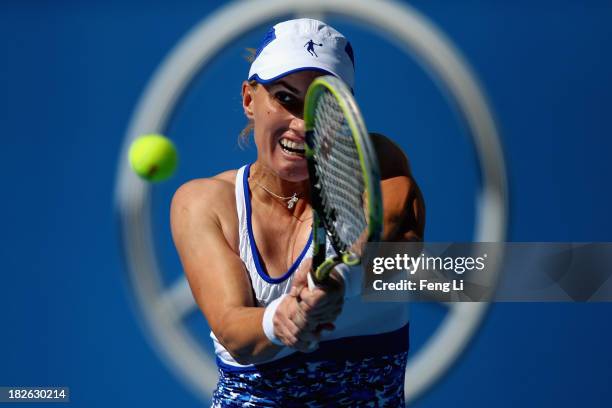 Svetlana Kuznetsova of Russia returns a shot during her women's singles match against Andrea Petkovic of Germany on day five of the 2013 China Open...