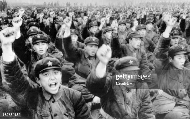 Picture released in April 1976 by Chinese official news agency showing a group of Chinese soldiers raising their fists and shouting slogans...