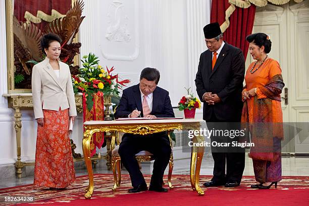 President of the people's Republic of China , Xi Jinping signs a credential book accompanied by Indonesian President Susilo Bambang Yudhoyono at the...