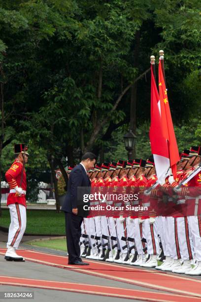 President of the people's Republic of China , Xi Jinping reviews observes an honour guard during his visit at presidential palace on October 2, 2013...