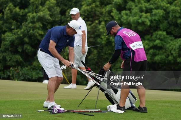 Scott Hend of Australia empties his golf bag on the 9th green on Day Three of the Vinpearl DIC Legends Vietnam at Vinpearl Resort Nha Trang on...