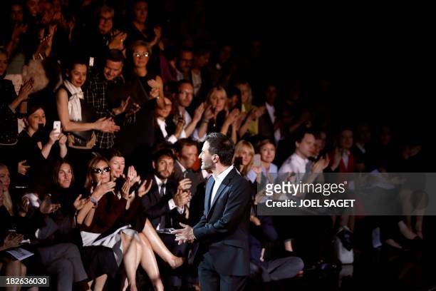 Designer Marc Jacobs acknowleges the public at the end of the Louis Vuitton 2014 Spring/Summer ready-to-wear collection fashion show, on October 2,...