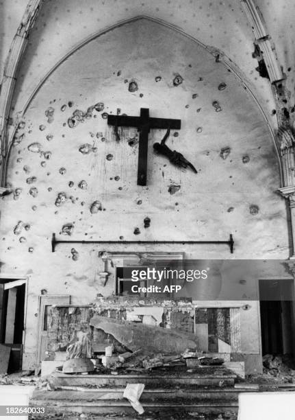 Photo dated May 16, 1974 representing a wooden Christ suspended by a arm in a church of Suez after israeli bimbongs during the Yom Kippur War.