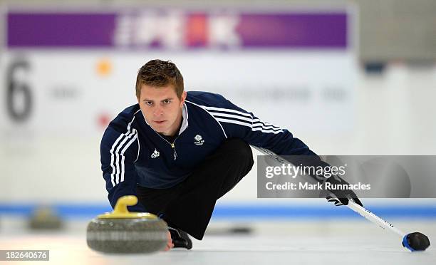 Scott Andrew throws a stone during a training session after being selected for the Team GB Curling team for the Sochi 2014 Winter Olympic Games at...