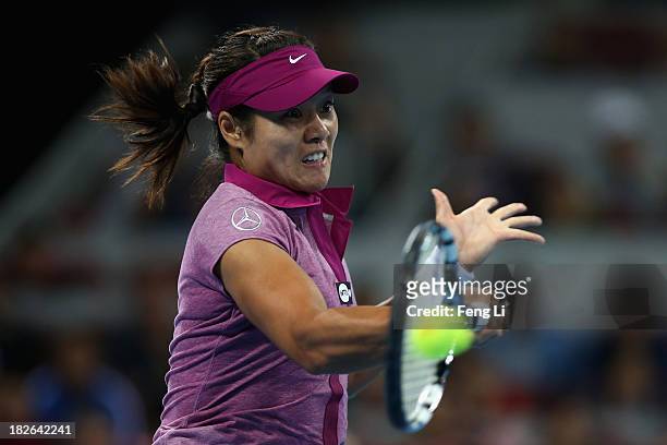 Li Na of China returns a shot during her women's singles match against Sabine Lisicki of Germany on day five of the 2013 China Open at the National...