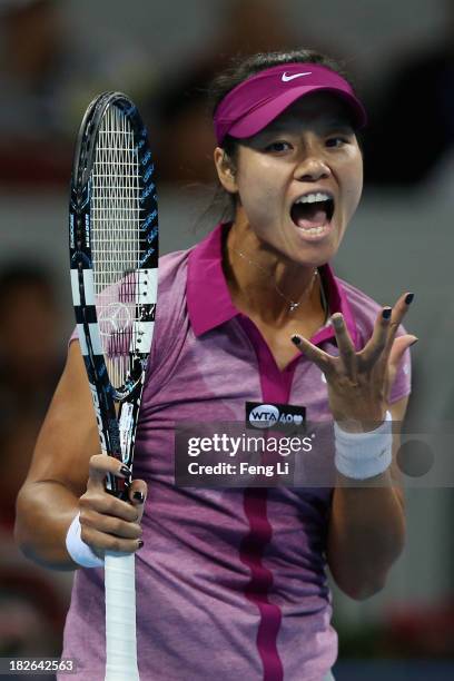 Li Na of China celebrates winning a ball against Sabine Lisicki of Germany during her women's singles match on day five of the 2013 China Open at the...