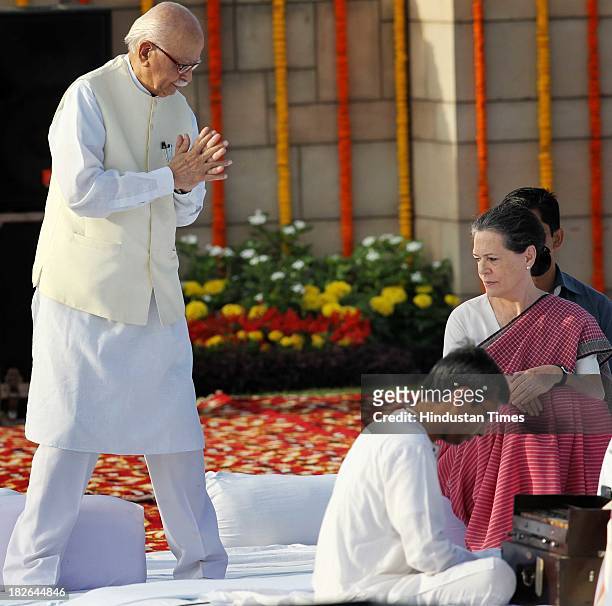 Chairperson and Congress President Sonia Gandhi and BJP Senior leader L K Advani paying homage to the Father of the Nation Mahatma Gandhi on the...