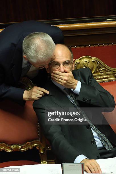 Prime Minister Enrico Letta chats with former Prime Minister Mario Monti as they attend the confidence vote for Letta's government at the Italian...