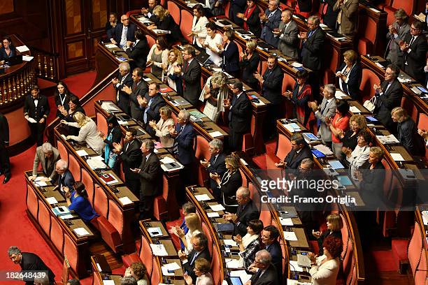 Senators of the center-left coalition applaude as Prime Minister Enrico Letta holds a speech prior to the confidence vote for his government at the...