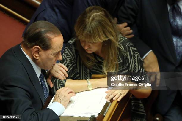 Former Prime Minister Silvio Berlusconi chats with Senator Alessandra Mussolini during the confidence vote for Enrico Letta's government at the...